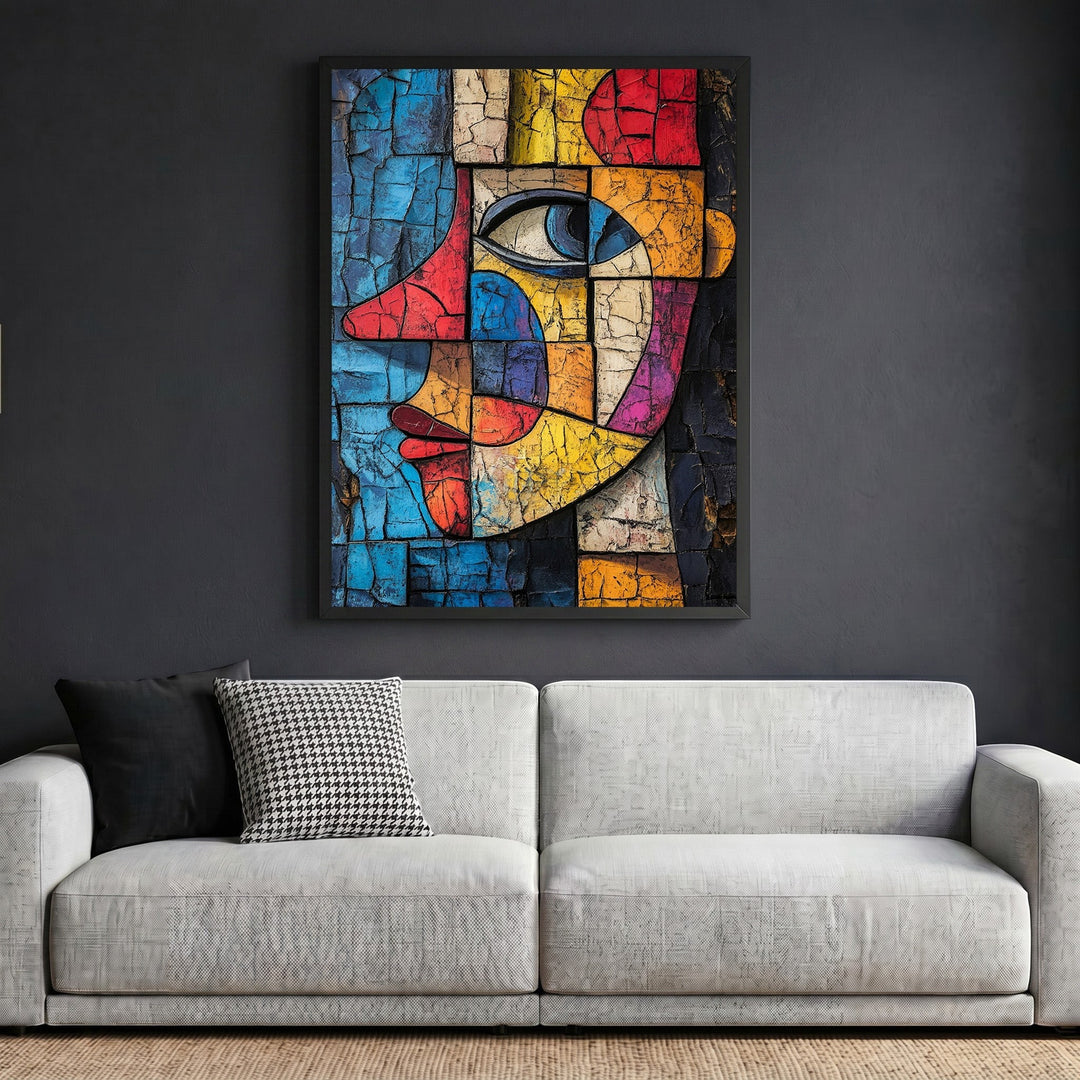 Wadi Home abstract geometric face wall art with cracked texture in vibrant colors, framed above a modern grey sofa.