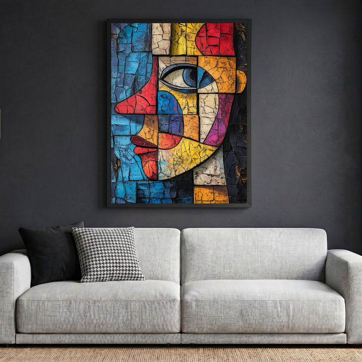 Wadi Home abstract geometric face wall art with cracked texture in vibrant colors, framed above a modern grey sofa.