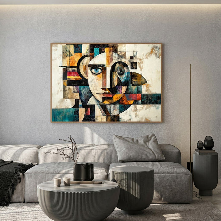 Wadi Home abstract geometric face canvas print featuring teal and ochre tones hanging above a modern grey sofa.
