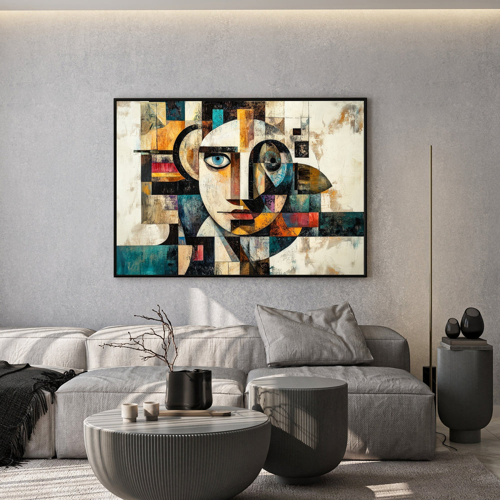Wadi Home abstract geometric face canvas print with teal and ochre tones displayed above a modern grey sofa.