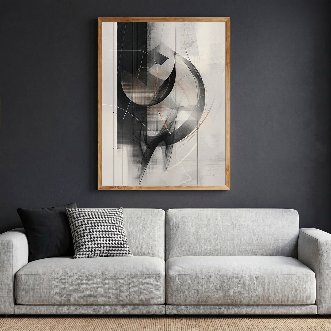 Wadi Home abstract geometric framed wall art in black, grey, and neutral tones hanging above a modern grey sofa.