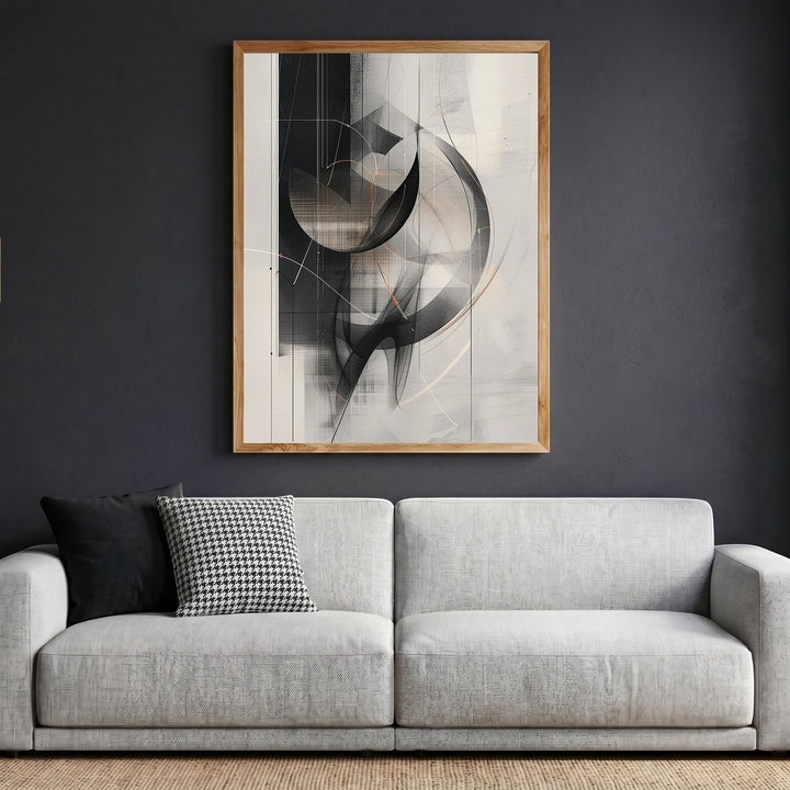 Wadi Home abstract geometric framed wall art in black, grey, and neutral tones hanging above a modern grey sofa.