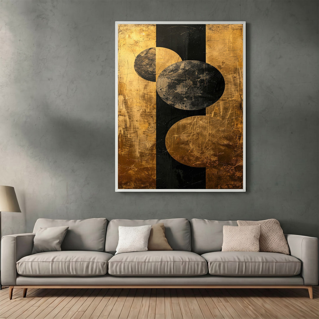 Wadi Home abstract geometric canvas print with black and metallic gold circles hanging above a modern grey sofa.