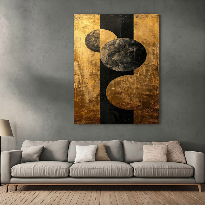 Wadi Home abstract geometric canvas art with black and metallic gold circles hanging above a modern grey sofa.