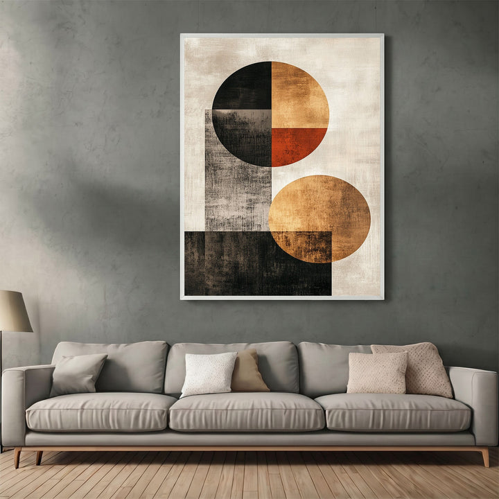 Wadi Home abstract geometric wall art print with black, ochre, and orange circles hanging above a modern sofa.