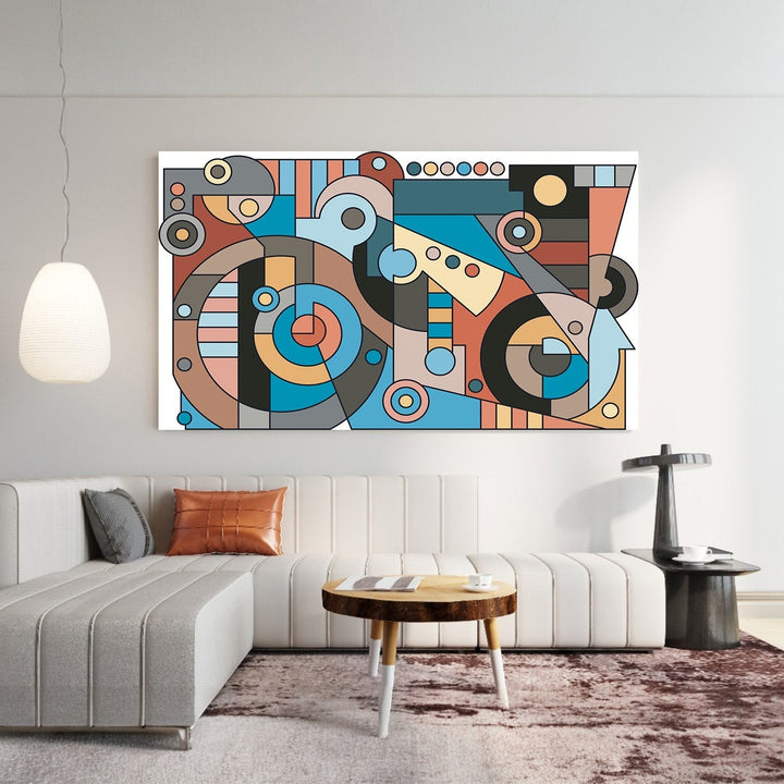 Wadi Home abstract geometric wall art print with blue, terracotta, and charcoal shapes hanging above a modern sofa.