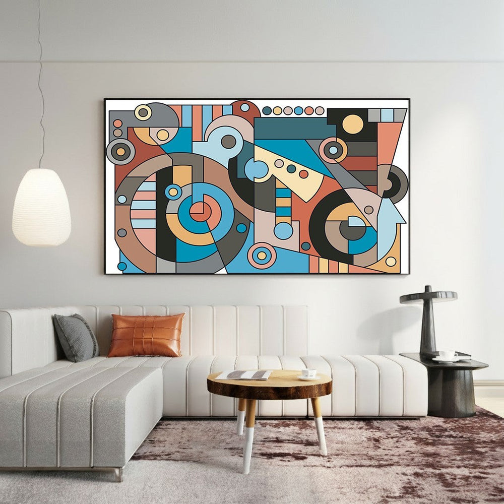 Wadi Home abstract geometric wall art print with blue, terracotta, and charcoal shapes hanging above a modern sofa.