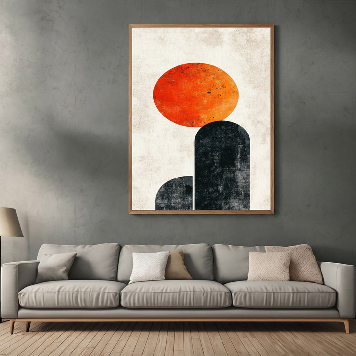 Wadi Home abstract geometric wall art print featuring a textured orange sun over charcoal arches in a wooden frame.
