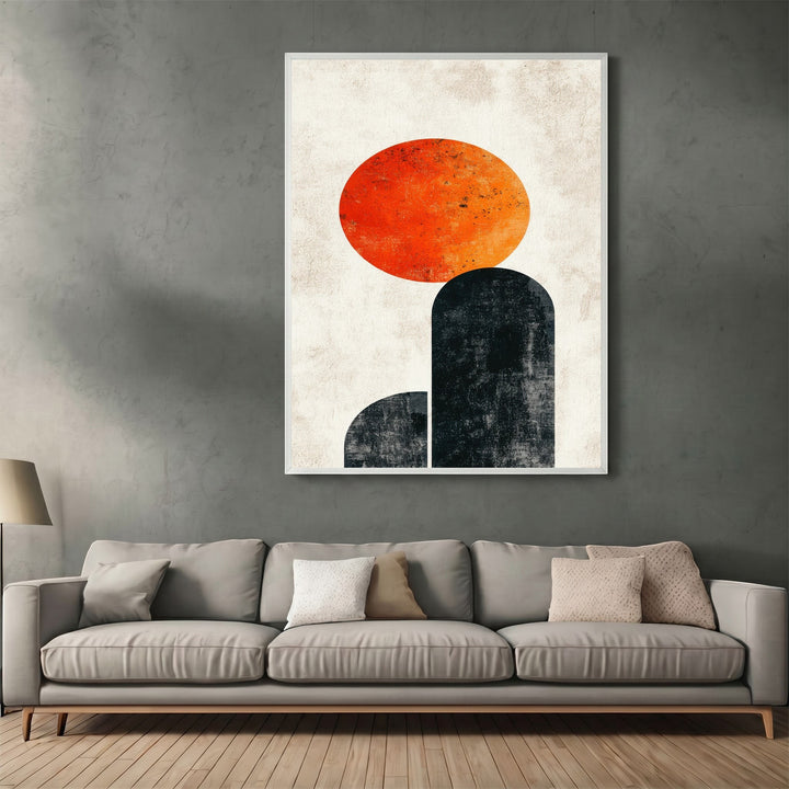 Wadi Home abstract geometric wall art print with orange sun and charcoal arches hanging above a modern grey sofa.