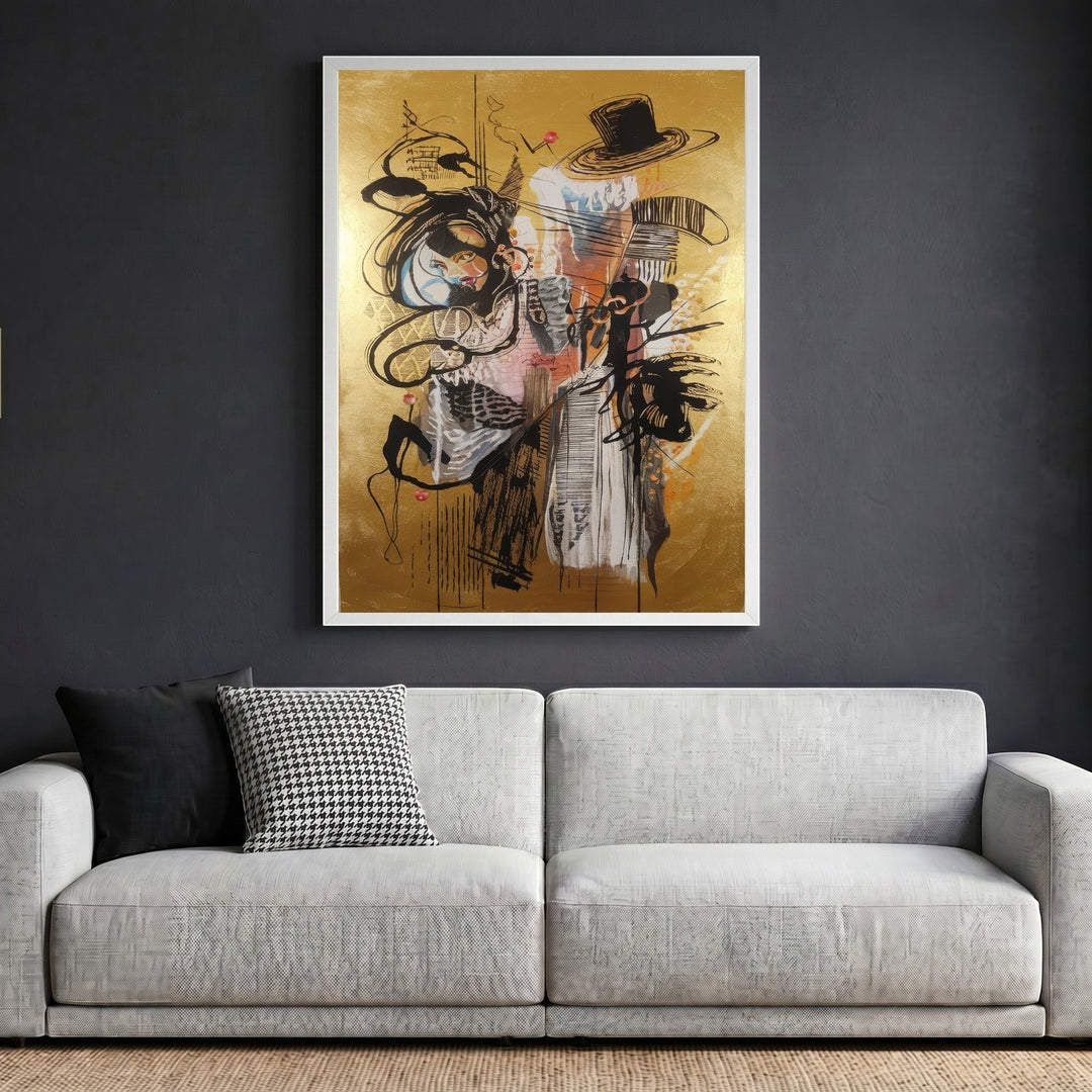 Wadi Home abstract expressionist framed wall art with black gestural lines on a metallic gold background above a sofa.