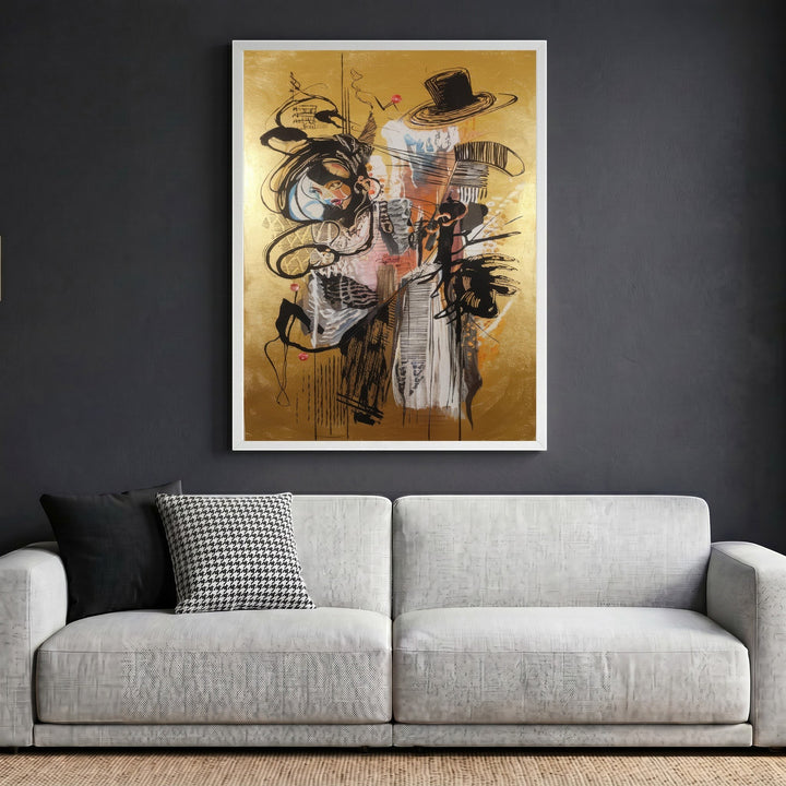Wadi Home abstract expressionist framed wall art with black gestural lines on a metallic gold background above a sofa.