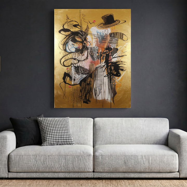 Wadi Home abstract expressionist framed wall art with black gestural lines on a metallic gold background above a sofa.