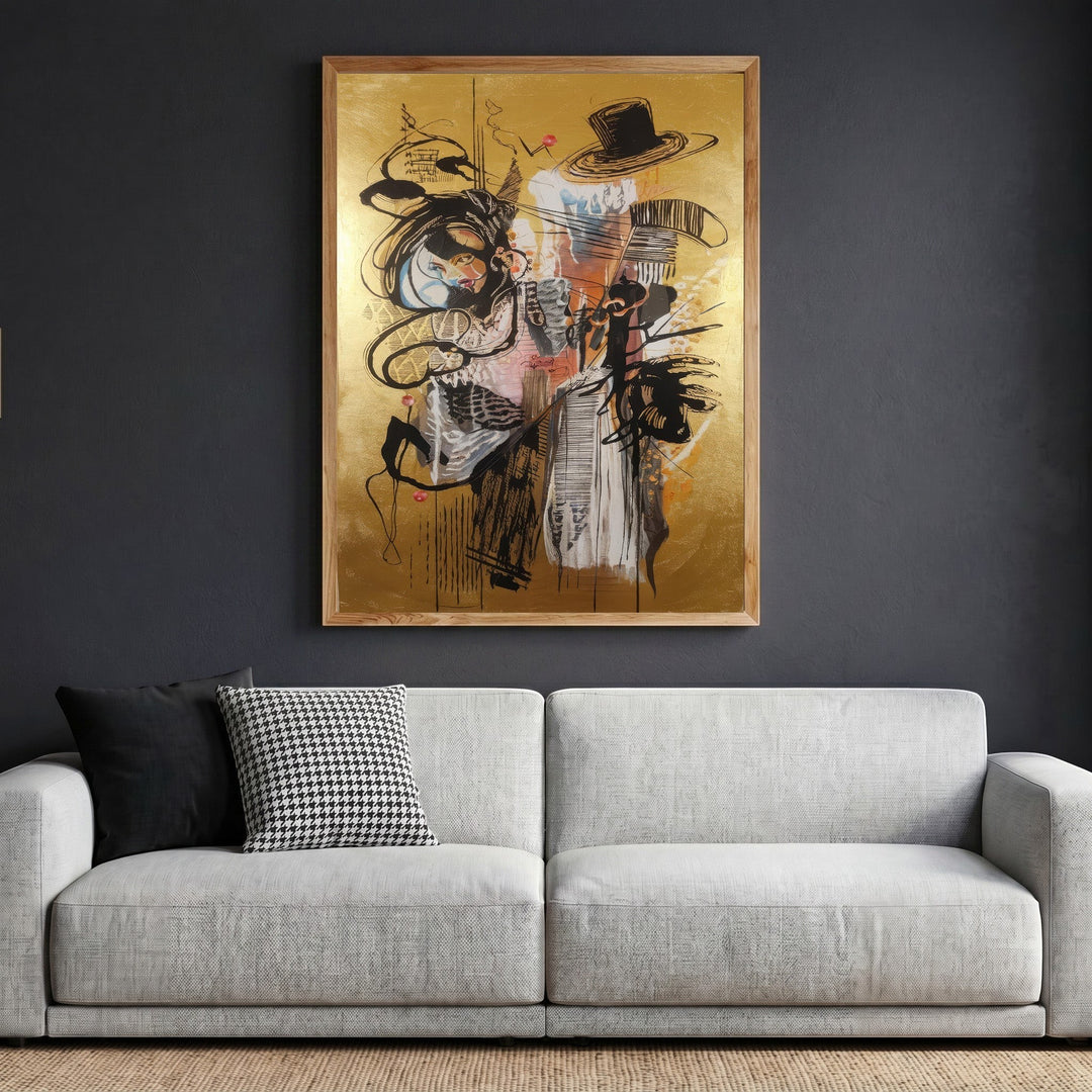 Wadi Home abstract expressionist framed wall art with gold background and black gestural lines hanging above a sofa.