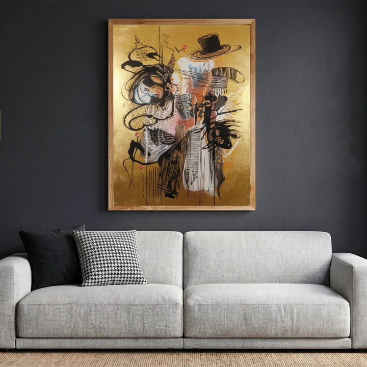 Wadi Home abstract expressionist framed wall art with gold background and black gestural lines hanging above a sofa.