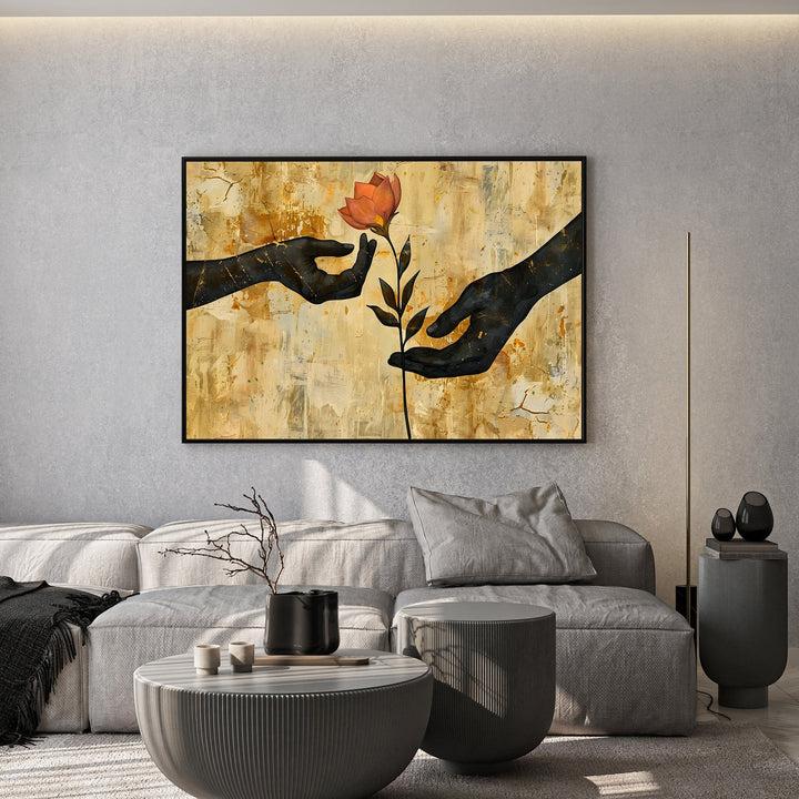 Wadi Home abstract wall art featuring black silhouettes of hands reaching for a flower on a textured gold background.