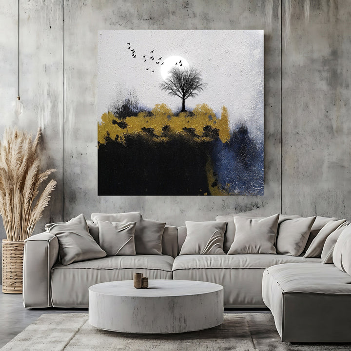 Wadi Home abstract landscape canvas art featuring a lone tree, moon, and gold accents above a modern grey sofa.