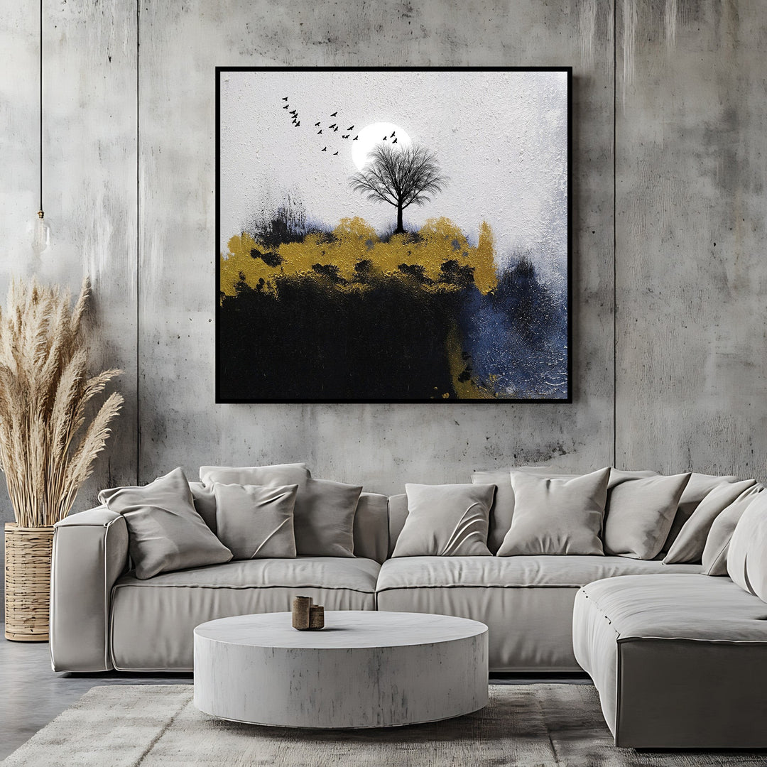 Wadi Home abstract landscape canvas art featuring a lone tree, moon, and gold accents hanging above a modern sofa.