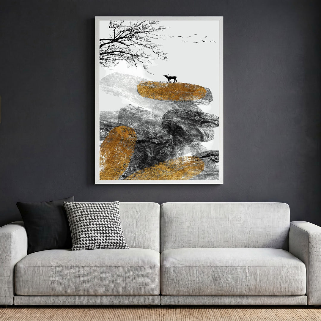 Wadi Home abstract landscape wall art featuring textured rocks, a deer, and gold accents in a white frame above a sofa.