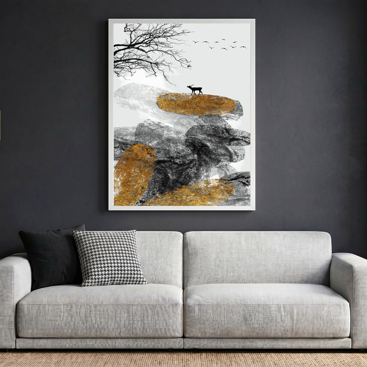 Wadi Home abstract landscape wall art featuring textured rocks, a deer, and gold accents in a white frame above a sofa.