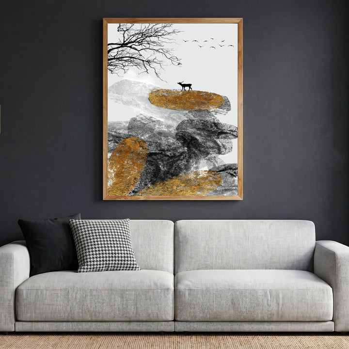 Wadi Home abstract landscape wall art with deer, textured rocks, and gold accents in a wooden frame above a sofa.