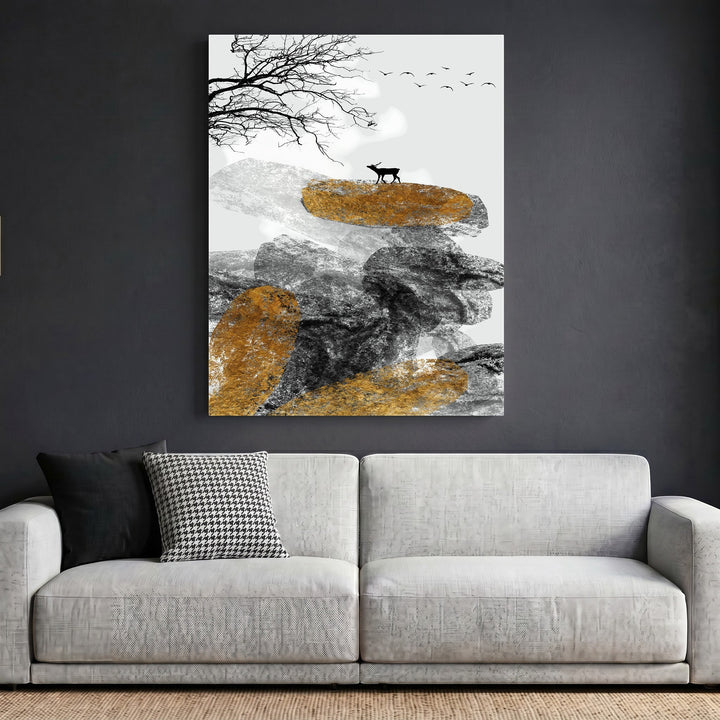 Wadi Home abstract landscape wall art featuring a deer, rock formations, and gold accents above a modern grey sofa.