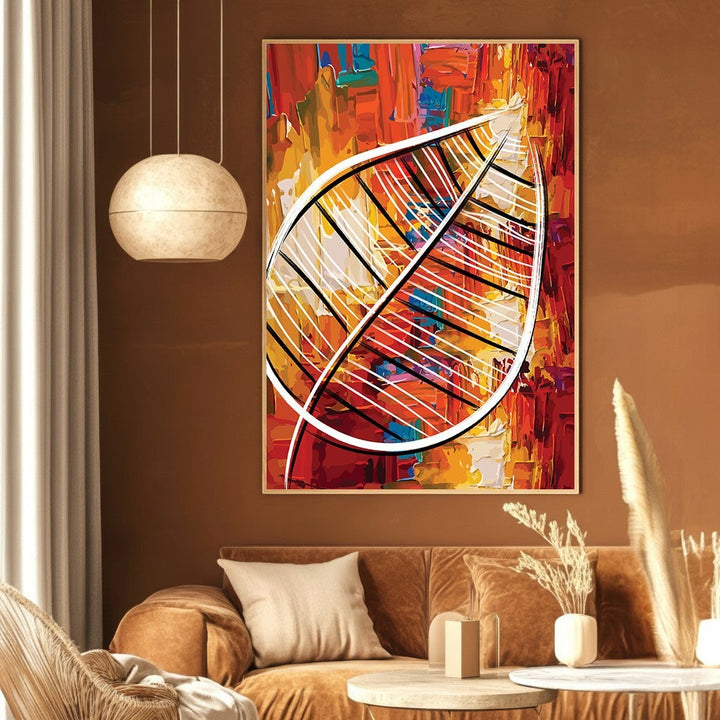 Wadi Home abstract leaf canvas print with textured red, orange, and yellow paint strokes on a brown living room wall.