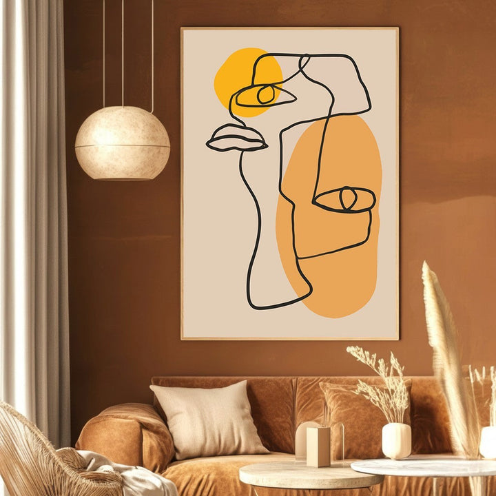Wadi Home abstract line art face print with yellow and ochre accents hanging in a modern living room.