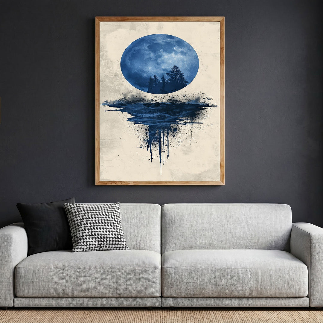 Wadi Home abstract moon landscape framed wall art with a blue moon and forest silhouette above a modern grey sofa.