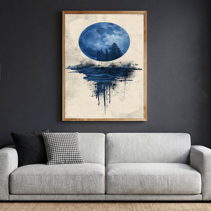 Wadi Home abstract moon landscape framed wall art with a blue moon and forest silhouette above a modern grey sofa.