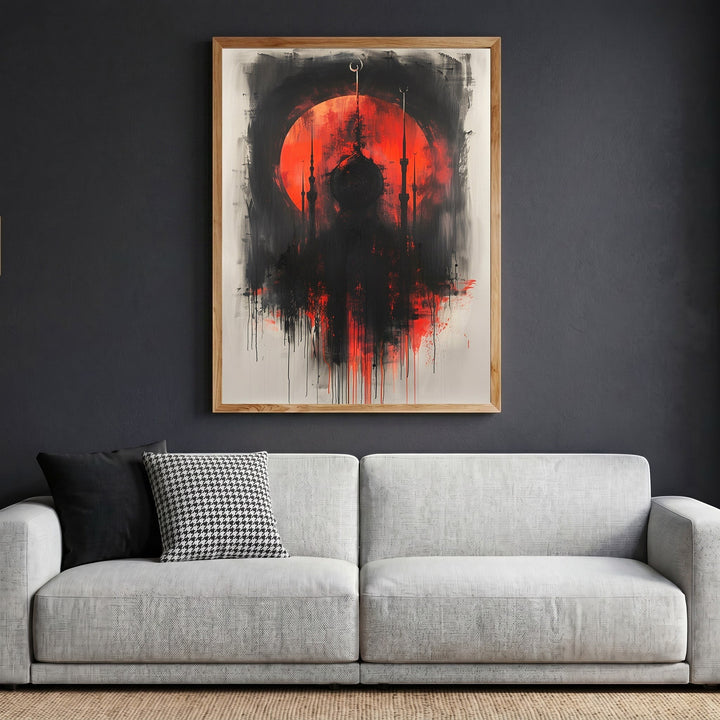 Wadi Home abstract mosque silhouette wall art with a fiery red sun and black brushstrokes in a wooden frame above sofa