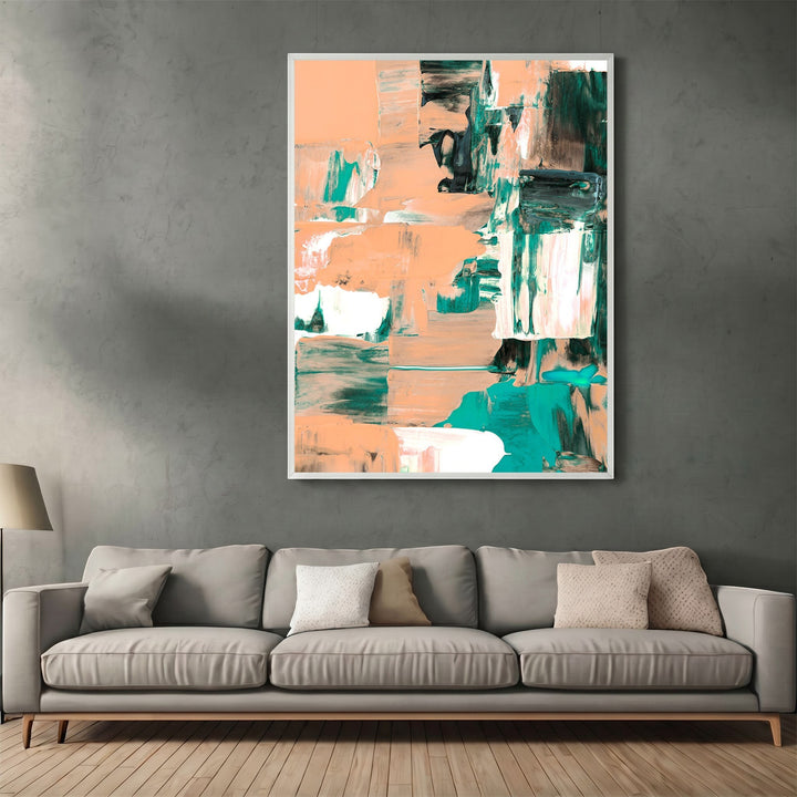 Wadi Home abstract expressionist canvas print with peach and forest green brushstrokes in a white frame above a sofa.