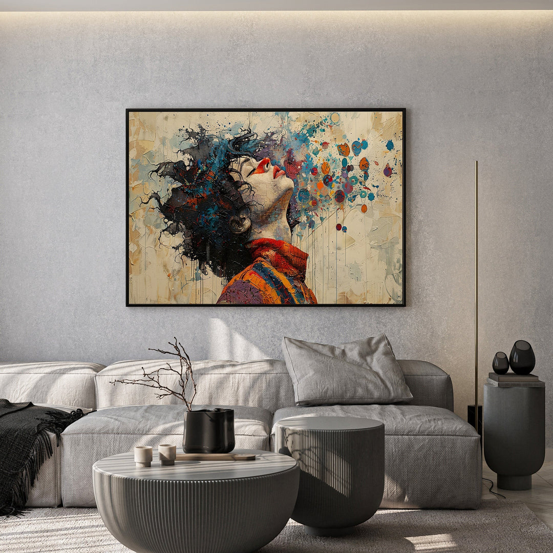 Wadi Home abstract portrait canvas print featuring vibrant paint splashes above a modern grey sofa in a living room.