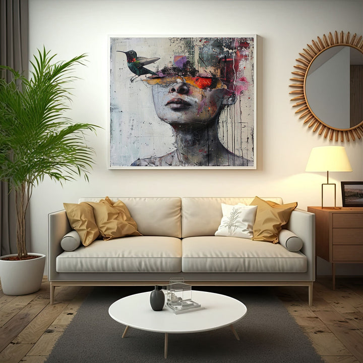 Wadi Home abstract portrait canvas print with hummingbird motif hanging above a modern beige sofa in a living room.