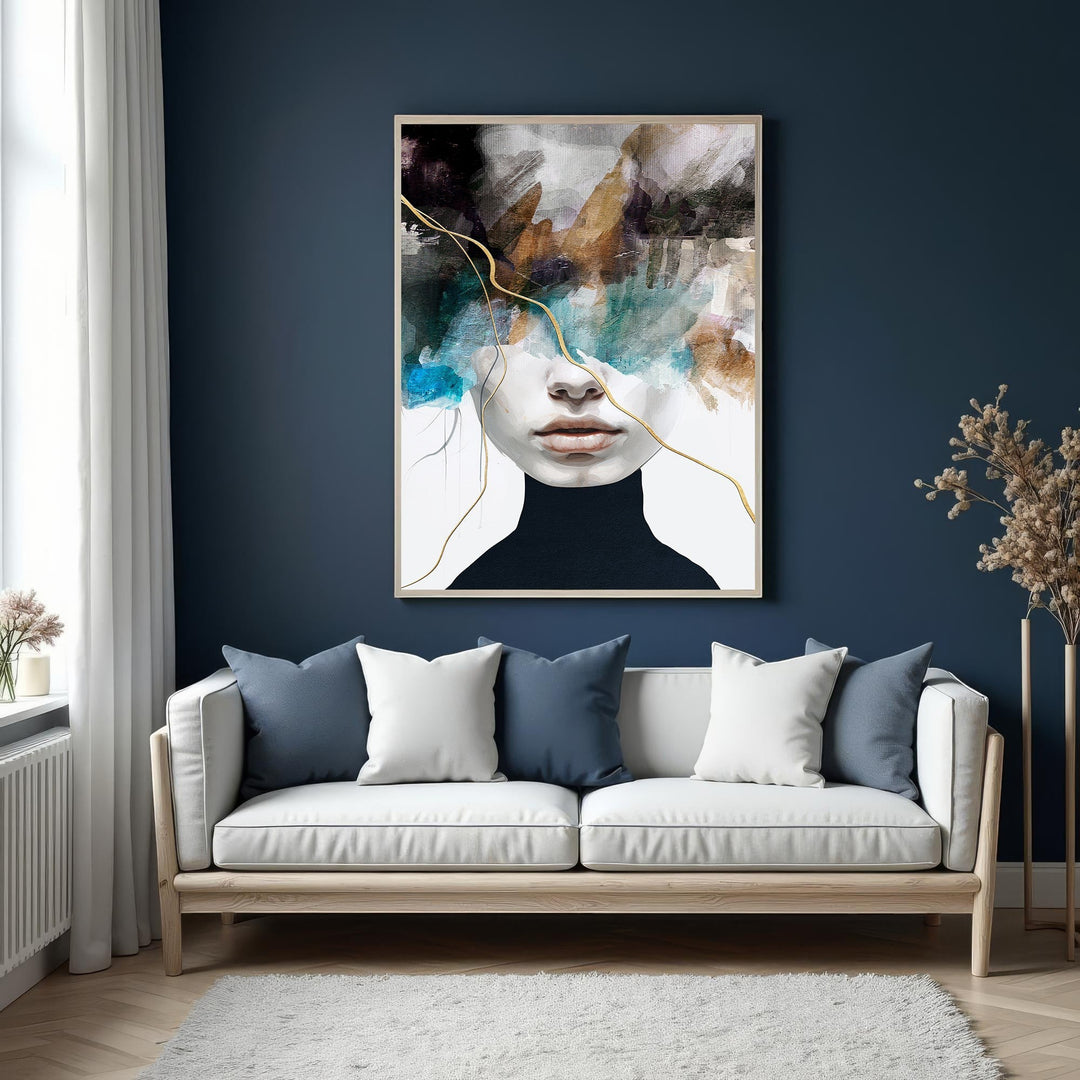 Wadi Home abstract portrait wall art featuring a face with muted tones, blue, brown, and gold accents, framed in a light wood finish.