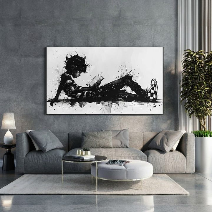 Wadi Home abstract black and white wall art of a child reading a book, with dynamic brushstrokes and ink splatters.