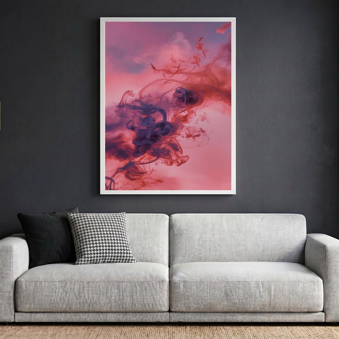 Wadi Home abstract smoke wall art print with violet and crimson swirls in a white frame above a modern grey sofa.
