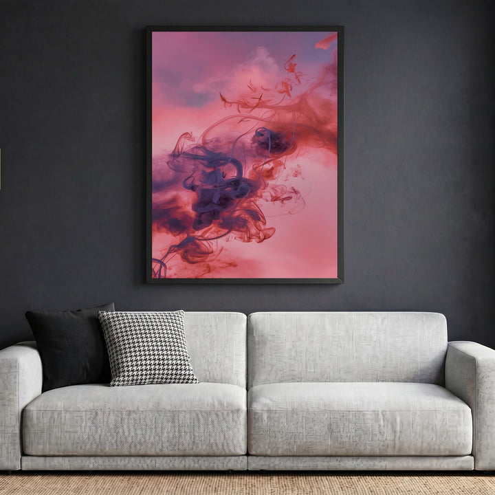 Wadi Home framed abstract smoke wall art with violet and crimson swirls displayed above a modern grey sofa.