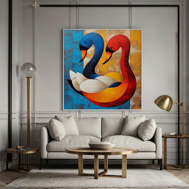 Wadi Home abstract swan duo canvas painting with blue and red geometric birds hanging above a modern grey sofa.