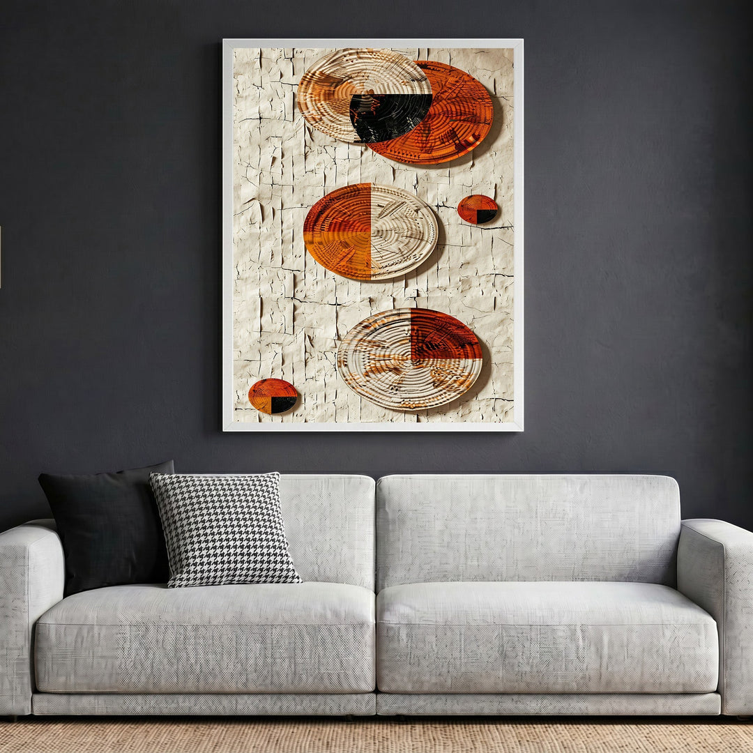 Wadi Home abstract wall art with terracotta and black woven circular elements on a textured cream plaster background.