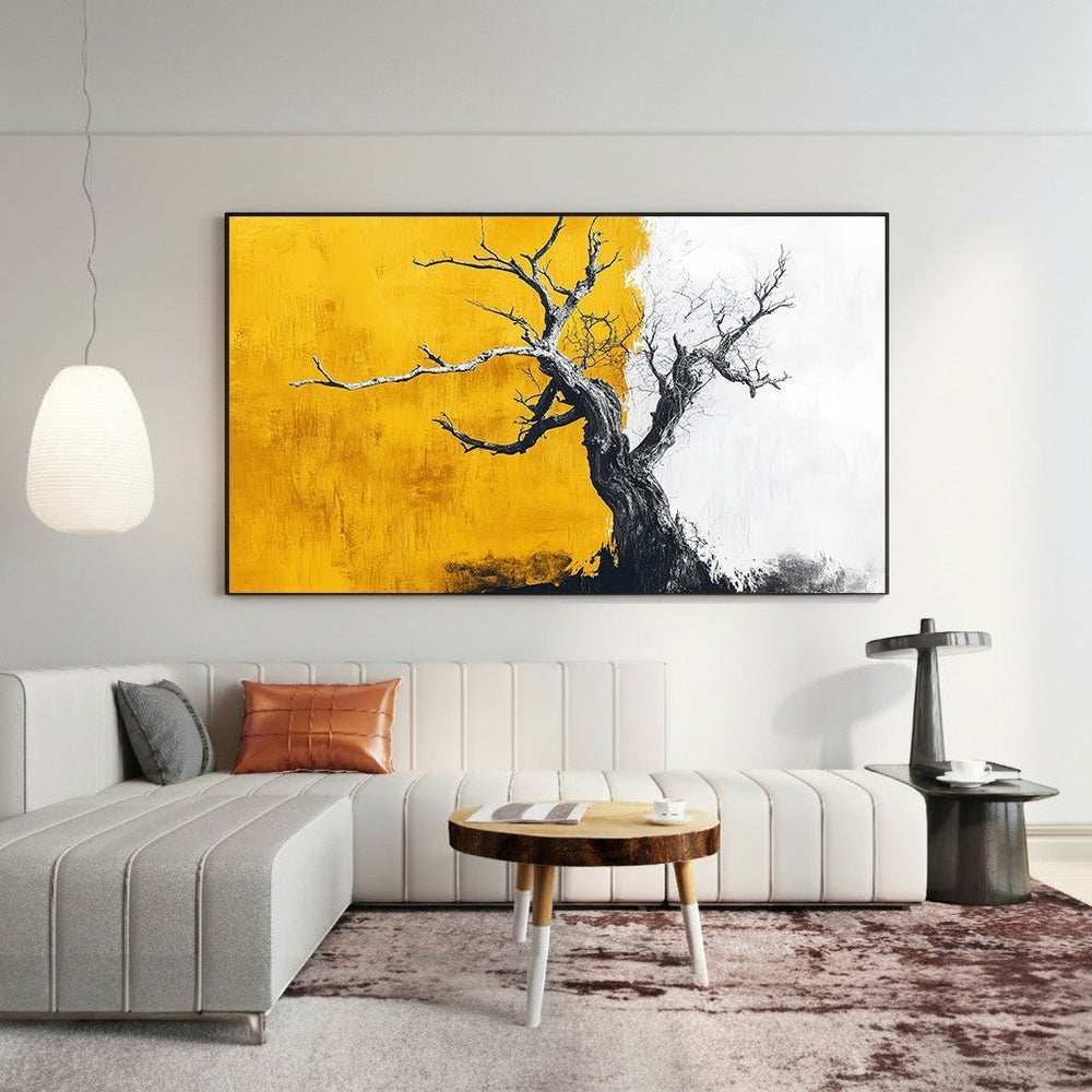 Wadi Home abstract tree landscape canvas print with yellow, white, and charcoal tones hanging above a modern sofa.