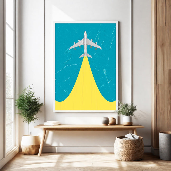 Wadi Home framed airplane ascending artwork with yellow contrail on blue background.