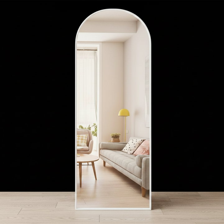 Wadi Home full length arched floor mirror with a sleek white frame standing in a modern living room interior.