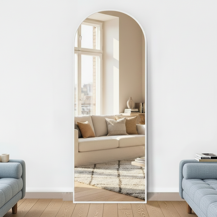 Wadi Home full length arched floor mirror with a minimalist white frame standing in a bright modern living room
