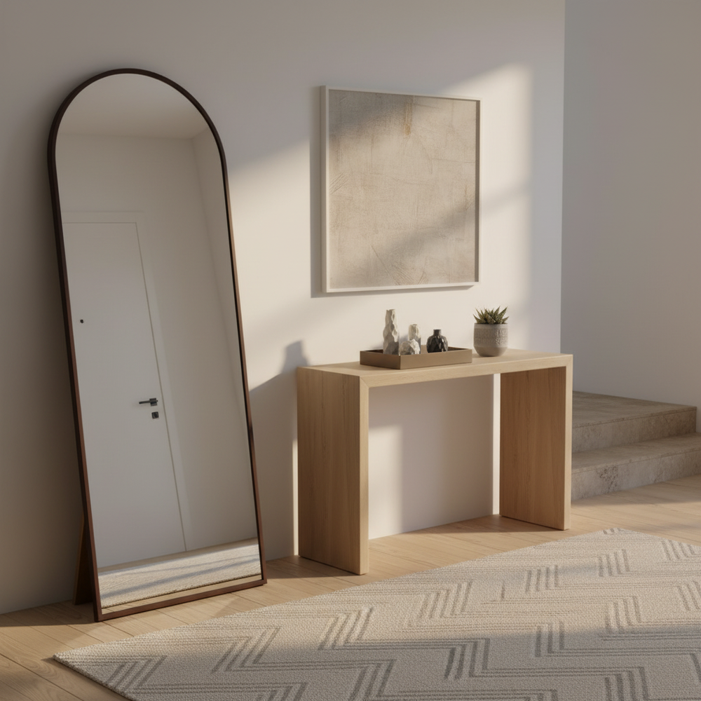 Wadi Home arched floor standing full length mirror with a dark wood frame leaning in a bright modern entryway.