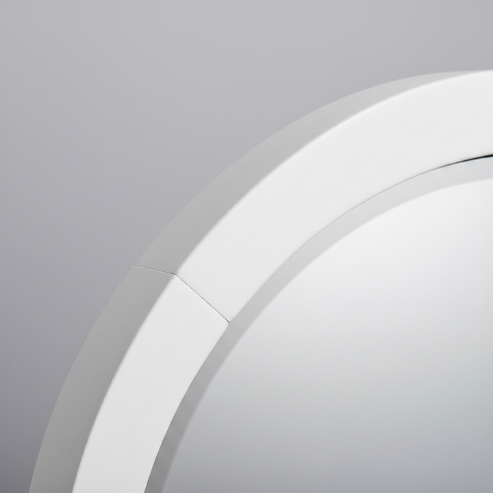 Close-up of the Wadi Home arched floor mirror featuring a smooth white wooden frame and high-clarity glass.
