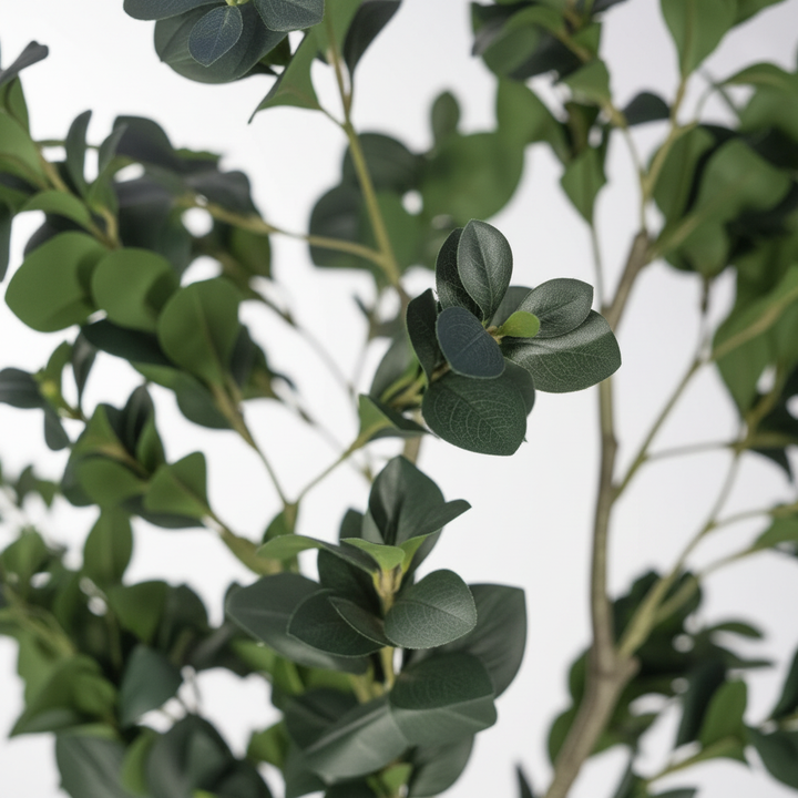 Close-up of Wadi Home artificial Aralia tree with lush, deep green textured leaves and realistic branches