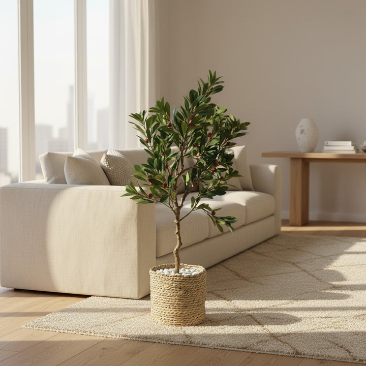 Wadi Home artificial bayberry tree with green leaves and red berries in a woven basket in a bright living room