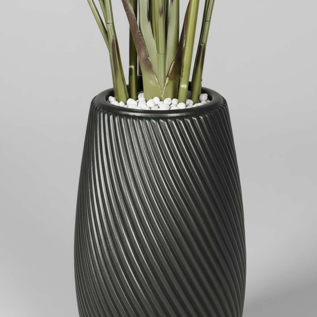 Wadi Home artificial Bird of Paradise plant in a black textured spiral planter with decorative white pebbles