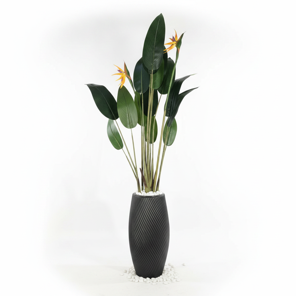 Wadi Home artificial Bird of Paradise plant with green leaves and orange blooms in a black textured spiral planter.