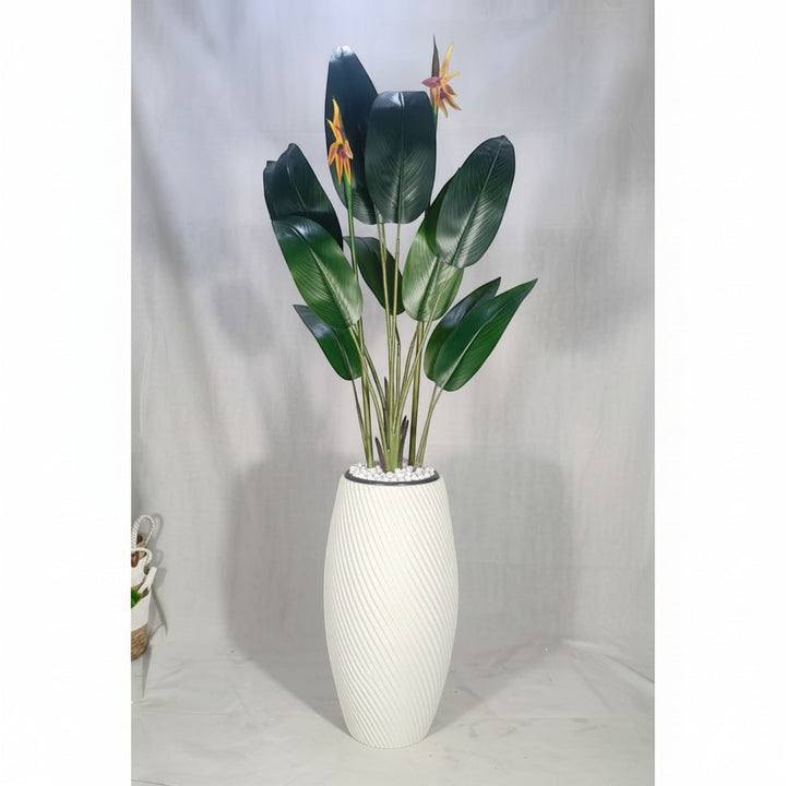 Wadi Home artificial Bird of Paradise plant with vibrant orange flowers and green leaves in a white spiral planter.